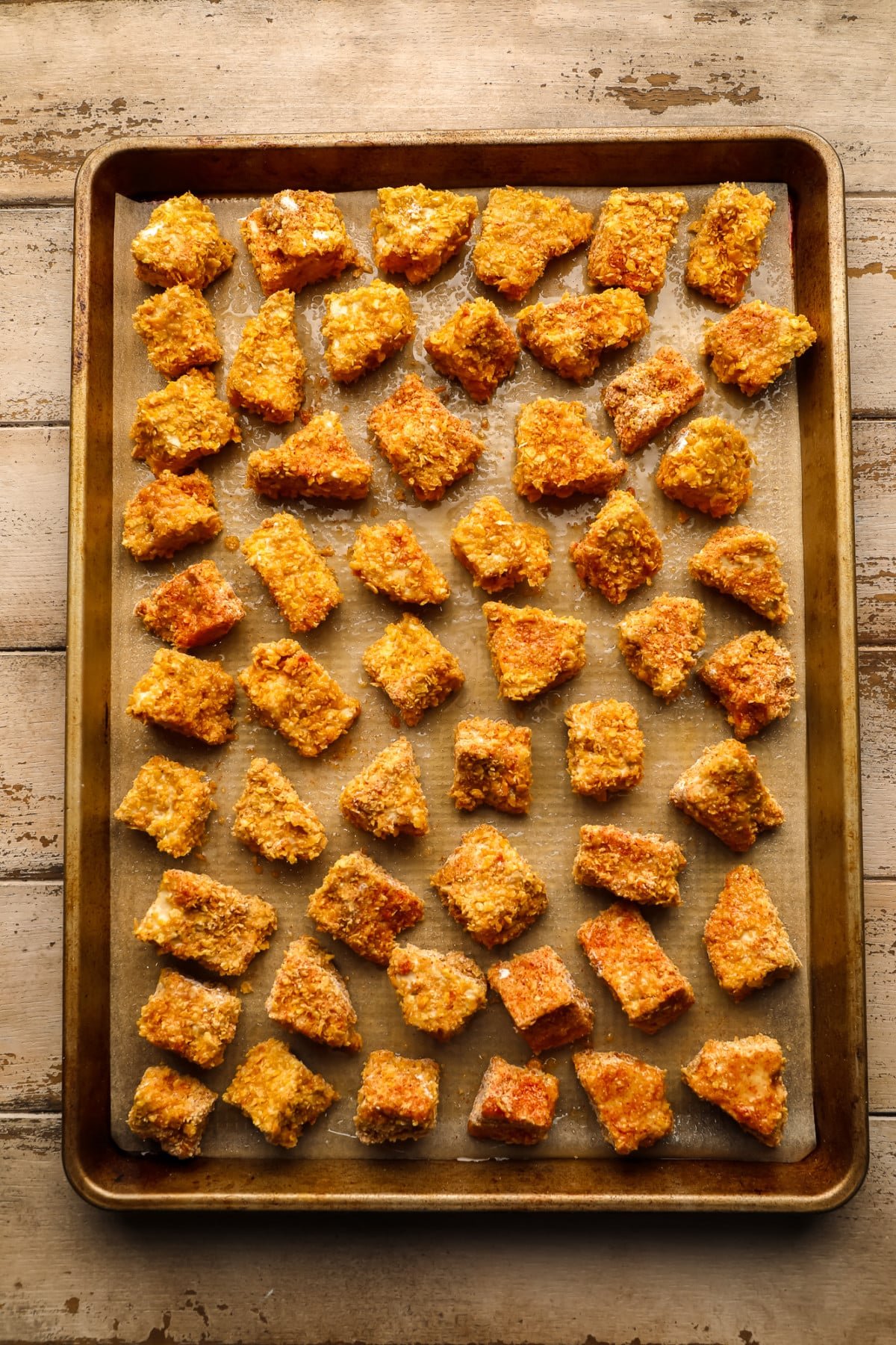 Tofu crocante em uma panela de ouro em fundo de madeira